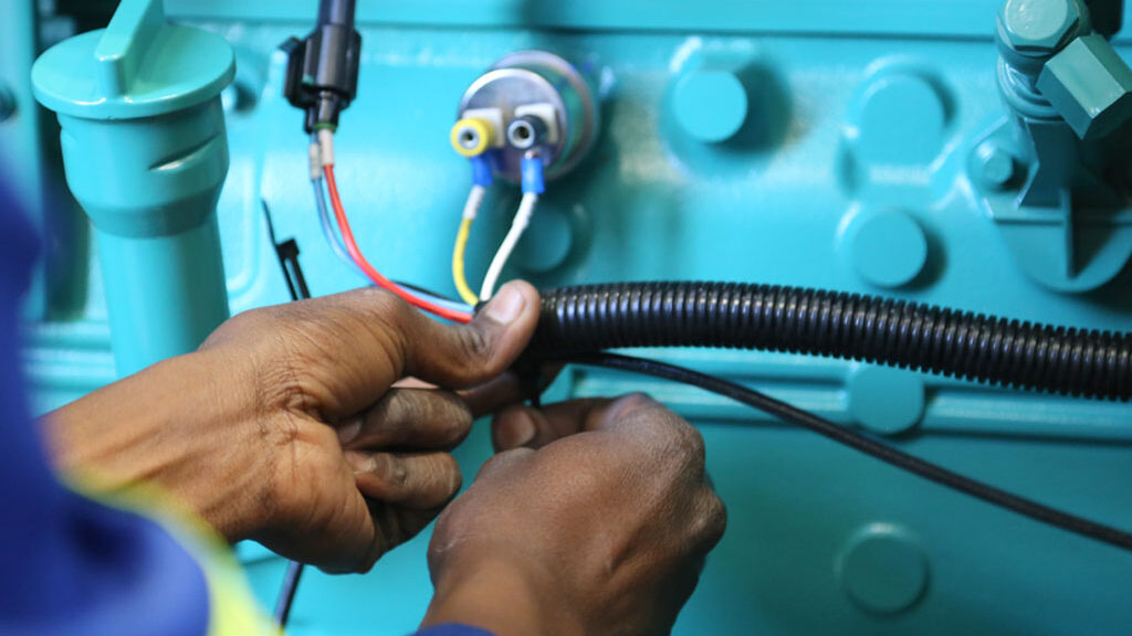 Technician wiring a Generator | Diesel Generator for Sale | Generator King